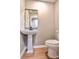 Modern powder room with pedestal sink and wood-look tile floor at 6733 Walker Rd, Riverdale, GA 30296