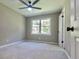 Well-lit bedroom featuring neutral walls and carpet flooring at 6733 Walker Rd, Riverdale, GA 30296
