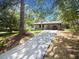 Front view of a white ranch house with a long driveway at 6733 Walker Rd, Riverdale, GA 30296