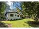 White brick house with black windows and lush lawn at 6733 Walker Rd, Riverdale, GA 30296