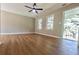 Bright living room featuring hardwood floors and a ceiling fan at 6733 Walker Rd, Riverdale, GA 30296