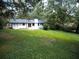 House's back and large backyard with green grass at 6733 Walker Rd, Riverdale, GA 30296