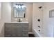 Modern bathroom with gray vanity and a tub shower combo at 6733 Walker Rd, Riverdale, GA 30296