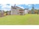 Two-story house with brick facade, large deck, and expansive lawn at 4847 Basingstoke Dr, Suwanee, GA 30024