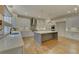 Modern kitchen with white cabinets, large island and hardwood floors at 4847 Basingstoke Dr, Suwanee, GA 30024