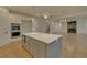 Open kitchen with gray island and hardwood floors at 4847 Basingstoke Dr, Suwanee, GA 30024