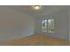 Bright bedroom with neutral carpeting and large window at 4847 Basingstoke Dr, Suwanee, GA 30024
