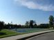 Outdoor basketball court with two hoops, surrounded by trees and grass at 4847 Basingstoke Dr, Suwanee, GA 30024