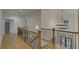 Upstairs hallway with hardwood floors and chandelier at 4847 Basingstoke Dr, Suwanee, GA 30024