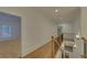 Upstairs hallway with hardwood floors and railing at 4847 Basingstoke Dr, Suwanee, GA 30024