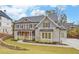 Two story house with gray brick, metal roof, and landscaping at 4847 Basingstoke Dr, Suwanee, GA 30024