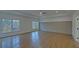 Spacious bedroom with hardwood floors and large windows offering natural light at 4847 Basingstoke Dr, Suwanee, GA 30024