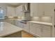 Modern kitchen with white cabinets, quartz countertops, and stainless steel appliances at 4847 Basingstoke Dr, Suwanee, GA 30024