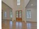 Bright and spacious entryway with hardwood floors and double doors at 4847 Basingstoke Dr, Suwanee, GA 30024