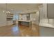 Island kitchen with white cabinets and hardwood floors at 4847 Basingstoke Dr, Suwanee, GA 30024