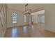 Formal dining room features hardwood floors, large windows, and elegant chandelier at 4847 Basingstoke Dr, Suwanee, GA 30024