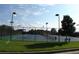 Well-maintained tennis courts with surrounding fence and seating area at 4847 Basingstoke Dr, Suwanee, GA 30024