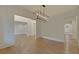 Spacious dining room with hardwood floors and modern chandelier at 4847 Basingstoke Dr, Suwanee, GA 30024
