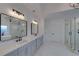Bathroom with double vanity, marble floors and modern lighting at 4847 Basingstoke Dr, Suwanee, GA 30024