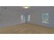 Bright bedroom with neutral carpeting and access to a private bathroom at 4847 Basingstoke Dr, Suwanee, GA 30024