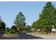 Gated community entrance with landscaped entryway at 4847 Basingstoke Dr, Suwanee, GA 30024