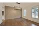 Dining room with hardwood floors, wall accents, and chandelier at 4847 Basingstoke Dr, Suwanee, GA 30024