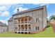 Two-story home with brick exterior and large deck at 4847 Basingstoke Dr, Suwanee, GA 30024
