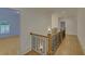 Upper hallway with hardwood floors and access to bedroom at 4847 Basingstoke Dr, Suwanee, GA 30024