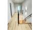 Modern hallway with hardwood floors and a sleek metal railing at 3562 Clubland Dr, Marietta, GA 30068