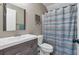 Bathroom with gray vanity, striped shower curtain, and toilet at 66 Danielle Dr, Dallas, GA 30157