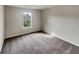 Bright bedroom with carpeted floor and large window at 96 Auburn Crossing Dr, Auburn, GA 30011