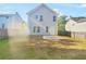 Rear view of a gray house with a small concrete patio and yard at 3853 Cress Way Dr, Decatur, GA 30034