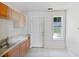 Simple kitchen with wood cabinets, stainless steel sink, and backyard view at 3853 Cress Way Dr, Decatur, GA 30034