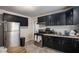 Kitchen with stainless steel appliances and dark cabinetry at 1962 Virginia Ave, College Park, GA 30337