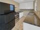 Modern kitchen with black appliances and granite countertops at 707 Pine Tree Trl # 10B, Atlanta, GA 30349