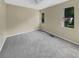 Bright bedroom with grey carpet and two windows at 707 Pine Tree Trl # 10B, Atlanta, GA 30349