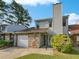Two-story townhome with stone facade and attached garage at 707 Pine Tree Trl # 10B, Atlanta, GA 30349