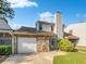 Front view of townhome, showcasing stone and garage at 707 Pine Tree Trl # 10B, Atlanta, GA 30349