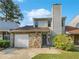 Two-story house with stone accents and a single-car garage at 707 Pine Tree Trl # 10B, Atlanta, GA 30349