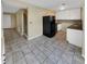 Kitchen with white cabinets, tile floors, and black appliances at 707 Pine Tree Trl # 10B, Atlanta, GA 30349