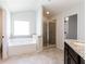 Bathroom with soaking tub, shower, and granite vanity at 1505 Clubhouse Ct, Mcdonough, GA 30252