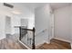 Upstairs hallway with wood flooring and iron railings at 1505 Clubhouse Ct, Mcdonough, GA 30252