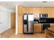 Modern kitchen with stainless steel appliances and wood cabinets at 3324 Peachtree Ne Rd # 2518, Atlanta, GA 30326