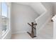 Upstairs hallway with neutral paint, carpet, and a staircase leading to the next floor at 1934 Granite Peak Nw Dr, Atlanta, GA 30318