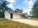 Attached garage with a long driveway and mature trees at 81 Primrose Ln, Powder Springs, GA 30127