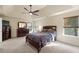 Spacious main bedroom with large windows and carpet at 2694 Dawning Day Dr, Dacula, GA 30019