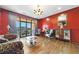 Bright living room with hardwood floors, red walls and balcony access at 3286 Northside Nw Pkwy # 1007, Atlanta, GA 30327