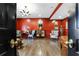 Red-walled living room with hardwood floors, comfortable seating, and a chandelier at 3286 Northside Nw Pkwy # 1007, Atlanta, GA 30327