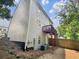 Townhome's rear elevation showcasing a deck, and a gravel backyard at 158 Prospect Path, Hiram, GA 30141