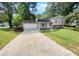 Ranch style home with attached garage and landscaping at 5351 Zachary Dr, Stone Mountain, GA 30083